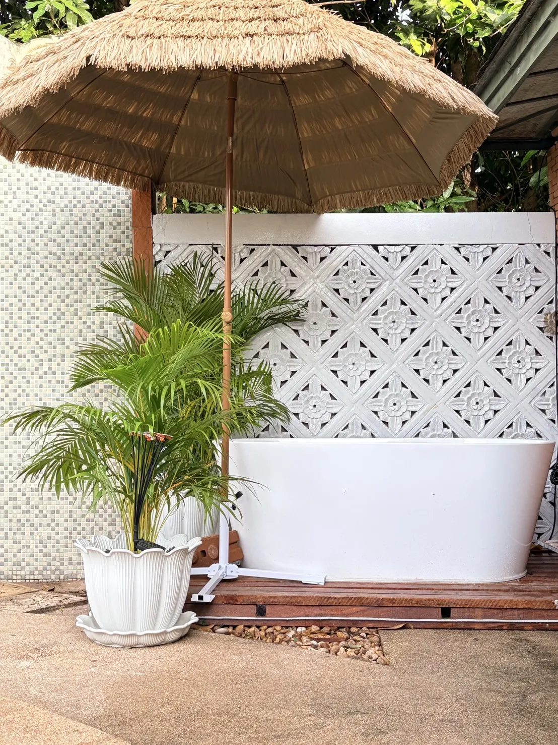 Outdoor balinese bath tub with thatched palm umbrella at Dewata Pattaya