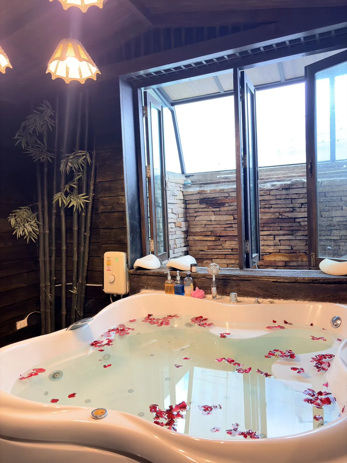 Private jacuzzi with rose petals and Asian lanterns at Dewata Wellness Sauna
